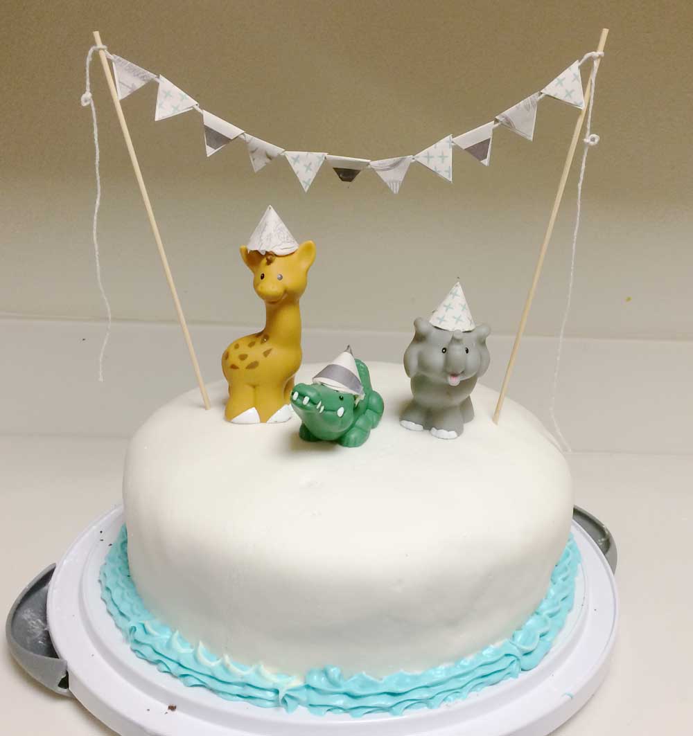 Simple First Birthday Cake with Party Animal Figures on Top