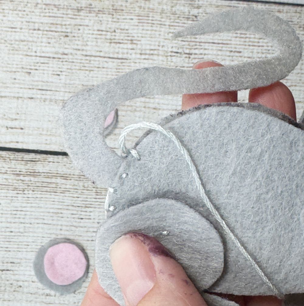 Using a running stitch at attach tail