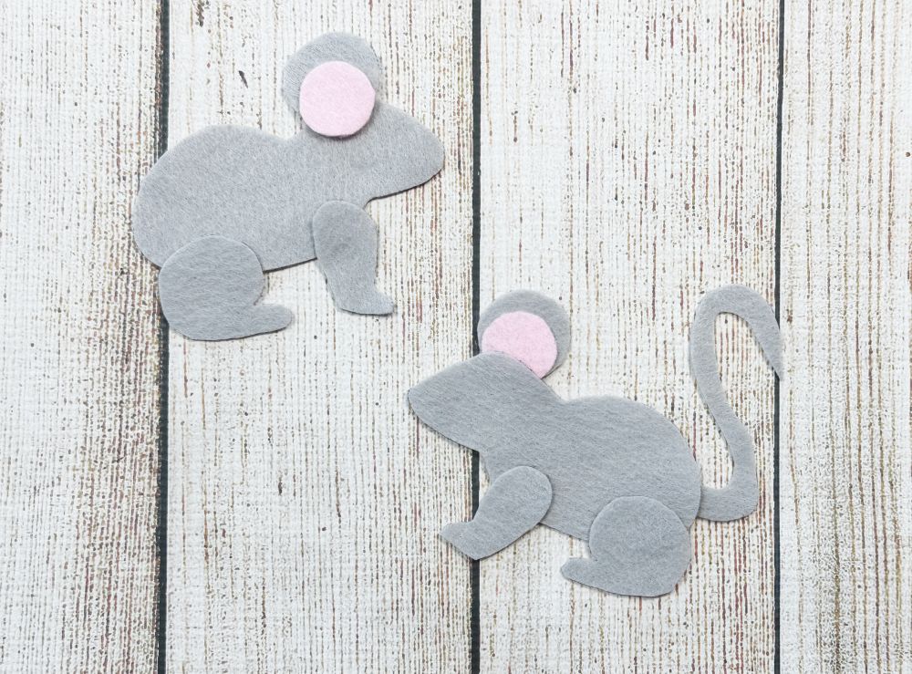 Supplies needed to sew a felt mouse, including thread, needle, stuffing, scissors, and printable pattern pieces, shown with the finished mouse plushie.