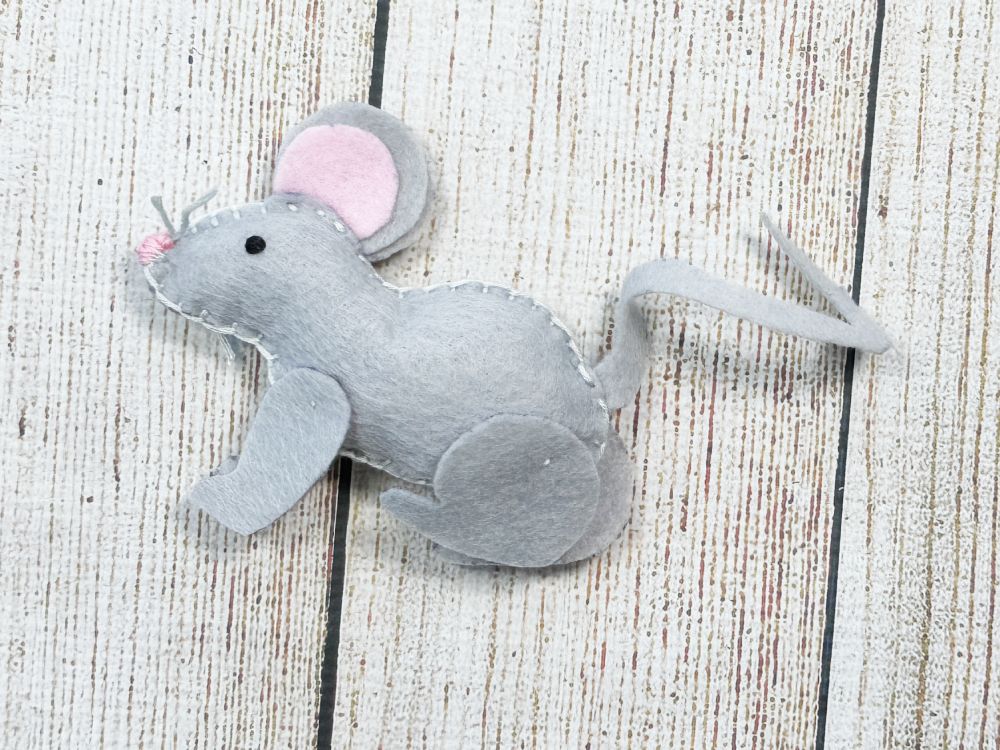 Completed handmade felt mouse plushie created with free printable sewing pattern.