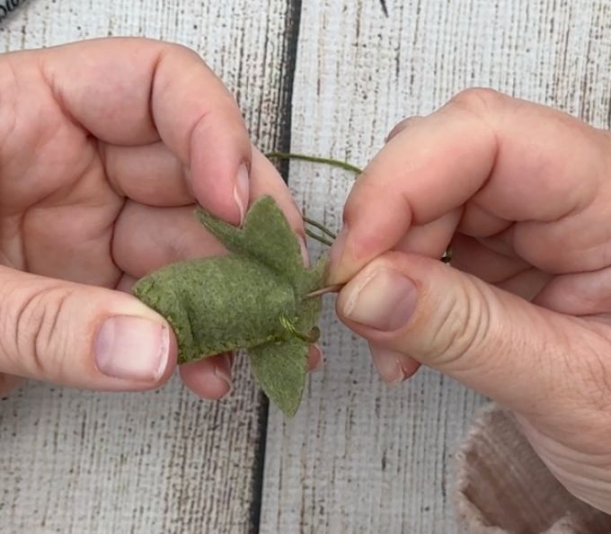 sewing the bottom of the felt pumpkin stem