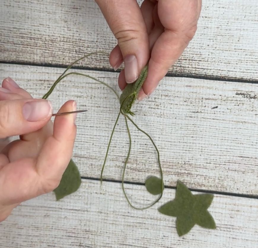 Sewing the stem of the felt pumpkin