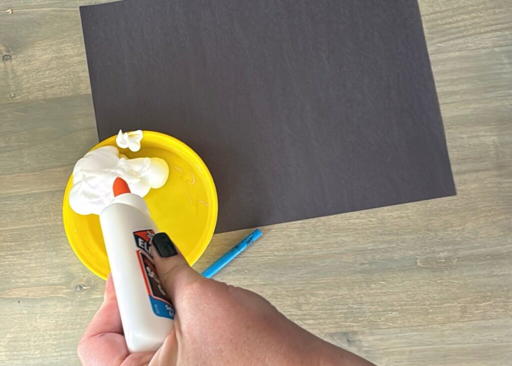 Quick and easy Letter N is for Night Sky craft with a mixture of glue and shaving cream painted on a piece of black craft paper