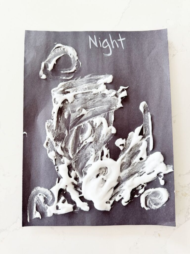 Quick and easy Letter N is for Night Sky craft with a mixture of glue and shaving cream painted on a piece of black craft paper