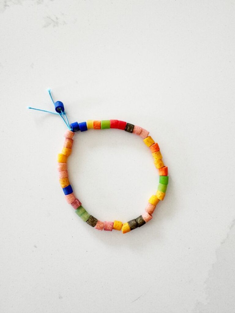 Letter N Noodle Necklace craft with dyed noodles strung on a necklace string to make a fun easy letter N craft for Preschool and Kindergarten