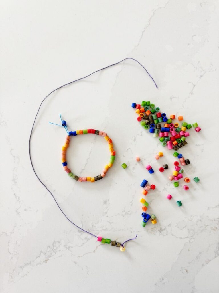 Letter N Noodle Necklace craft with dyed noodles strung on a necklace string to make a fun easy letter N craft for Preschool and Kindergarten