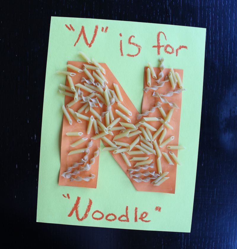 Letter N Noodle craft with different kinds of noodles glued to a letter N to make a fun tactile craft
