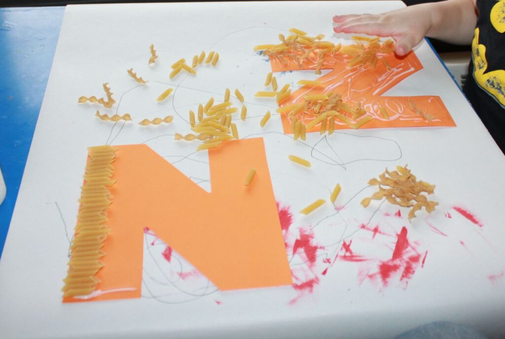 Letter N Noodle craft with different kinds of noodles glued to a letter N to make a fun tactile craft