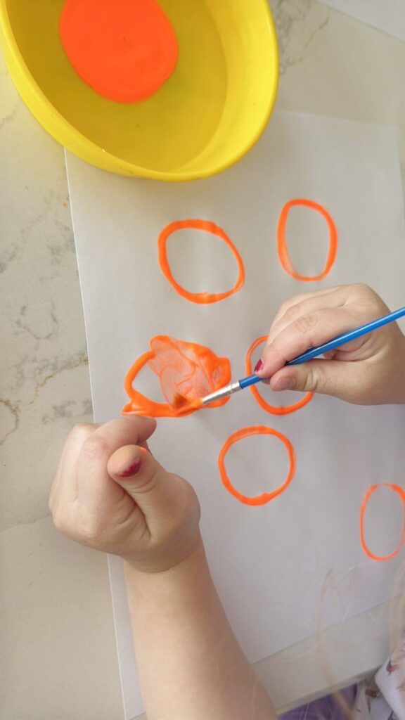 Letter O is for Orange Orchard Stamp Activity painting in oranges after stamping