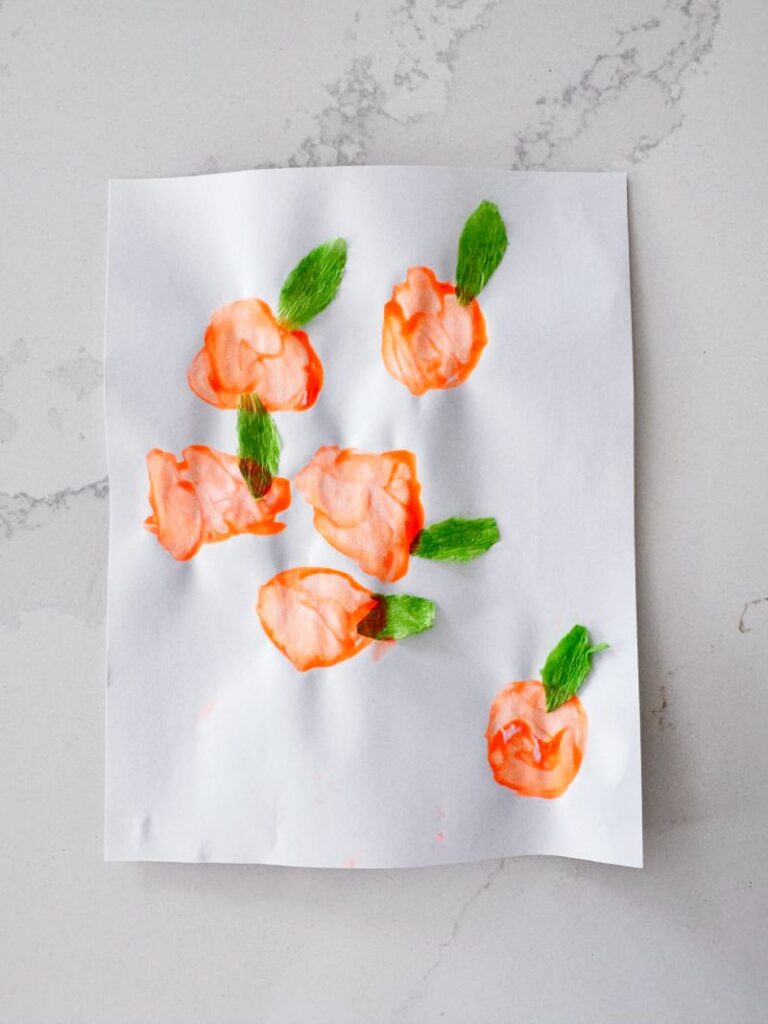 Letter O is for Orange Orchard Stamp Activity stamping with a paper tube and orange paint
