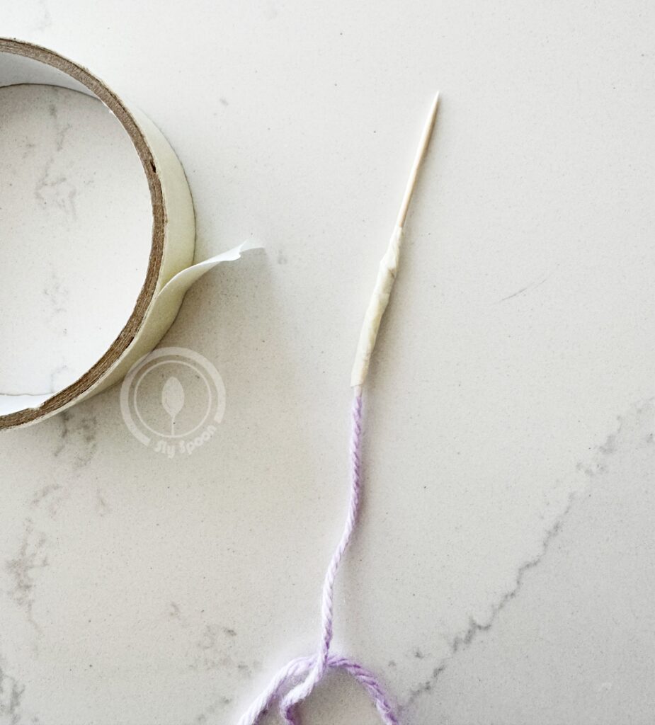 Preschooler needle made of yarn tapped to a tooth pick