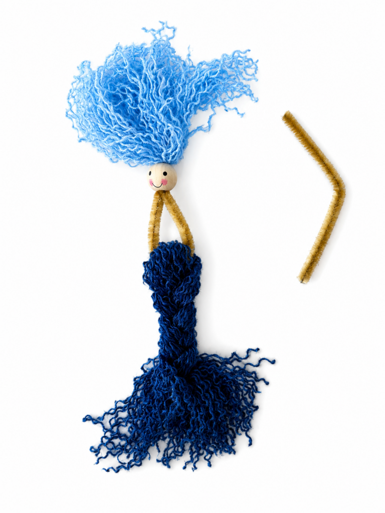 Shaping the body of a beginner fiber art mermaid with pipe cleaners.