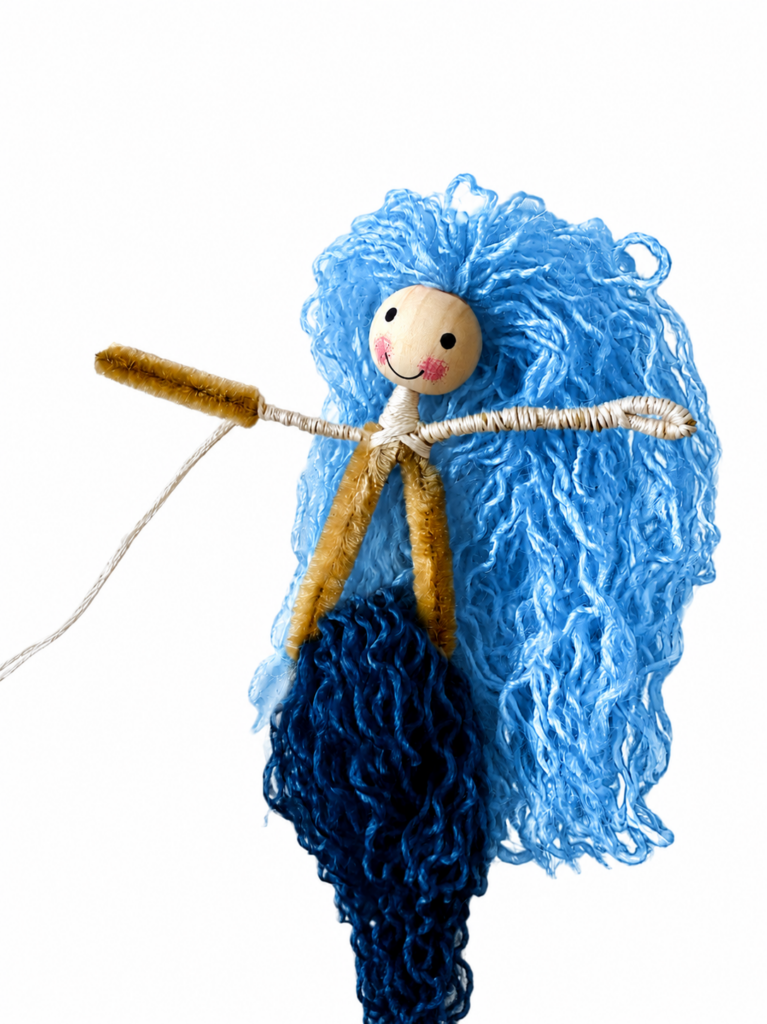 Wrapping yarn to create the tail for a DIY string art mermaid.