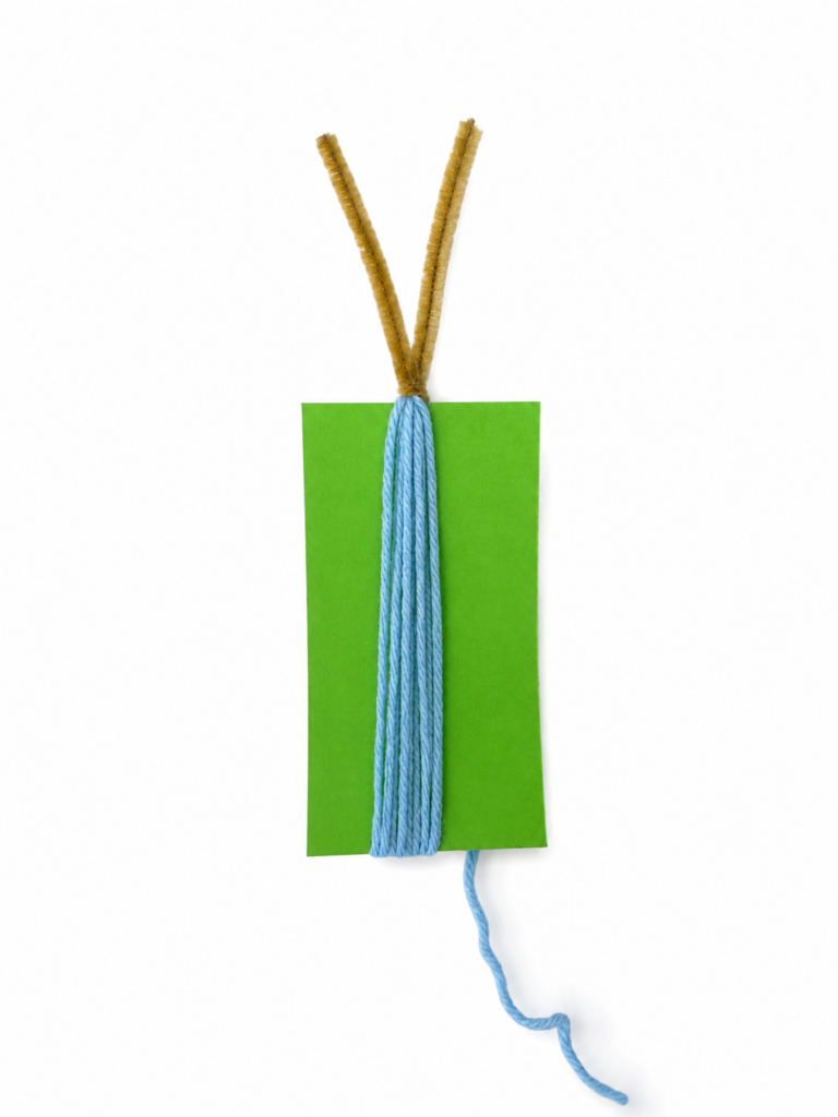 Wrapping yarn to begin making a DIY fiber art mermaid.