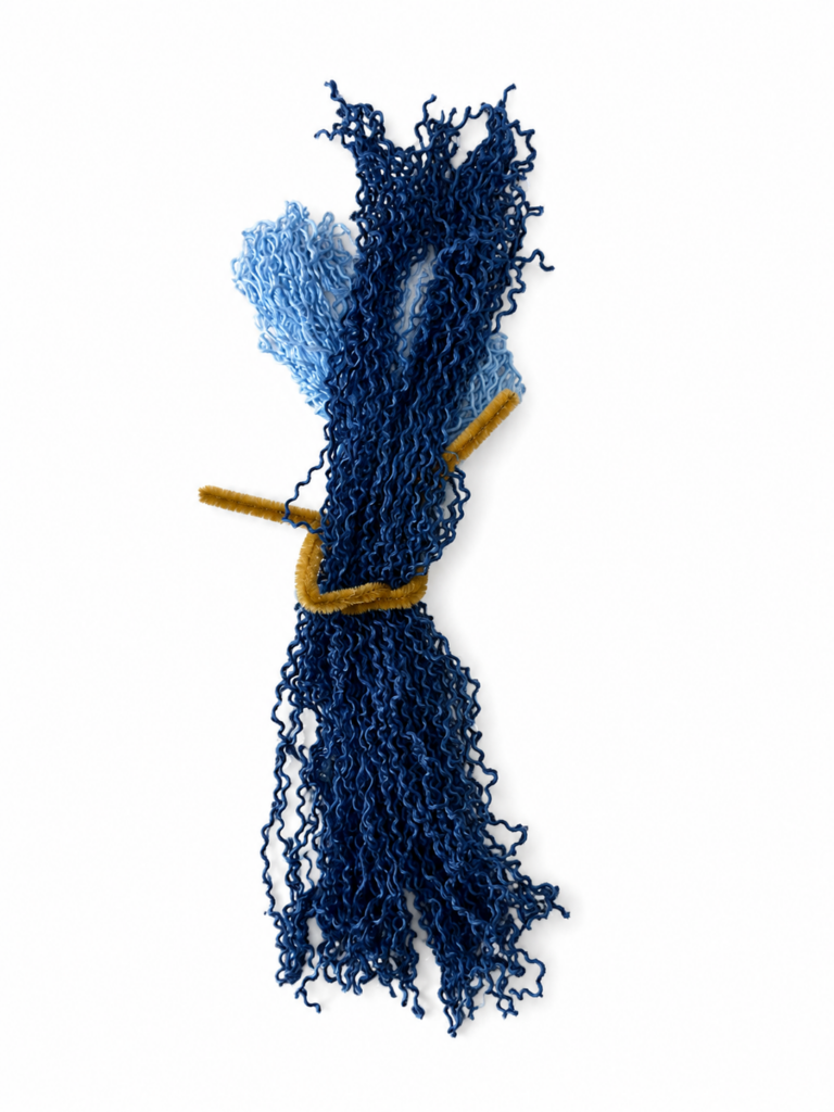 Wrapping yarn to create the tail for a DIY string art mermaid.