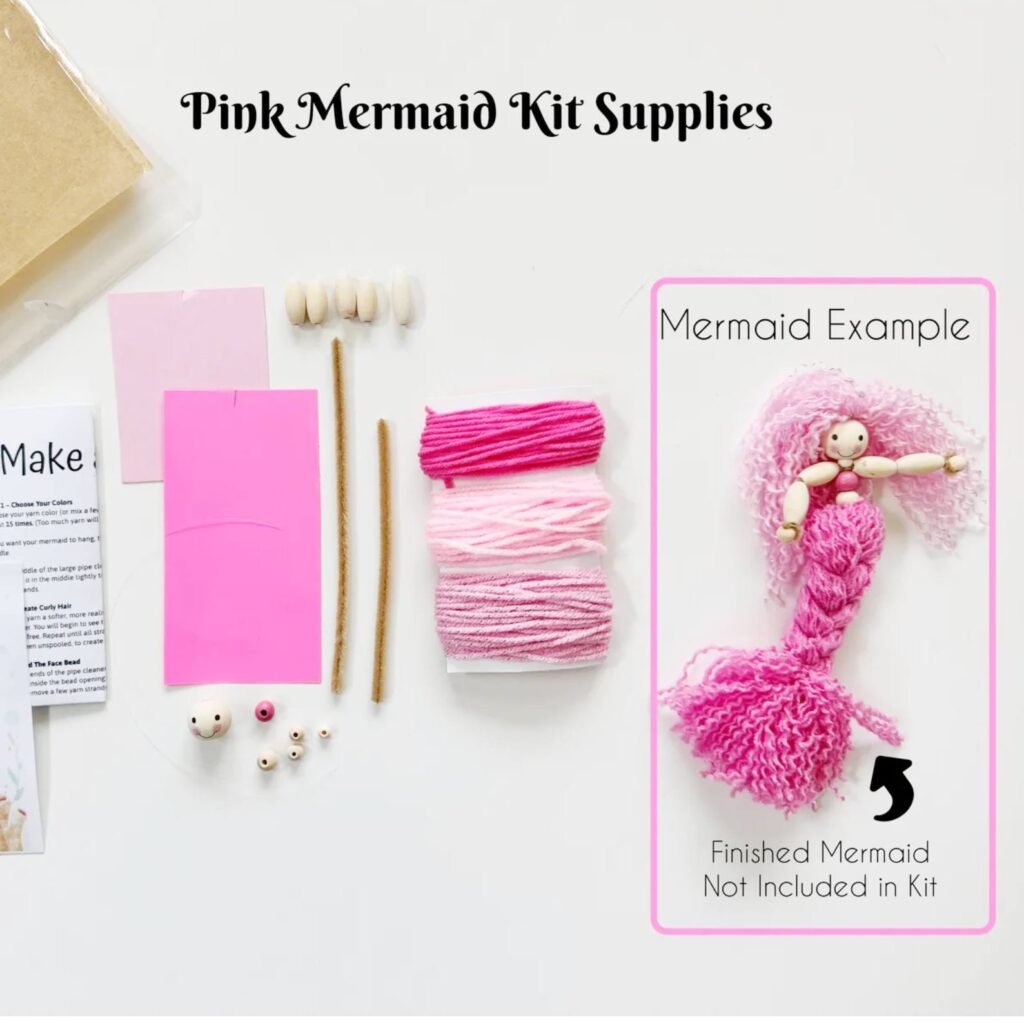 Supplies for an easy DIY mermaid doll craft including wooden beads, yarn, pipe cleaners and measuring cards.