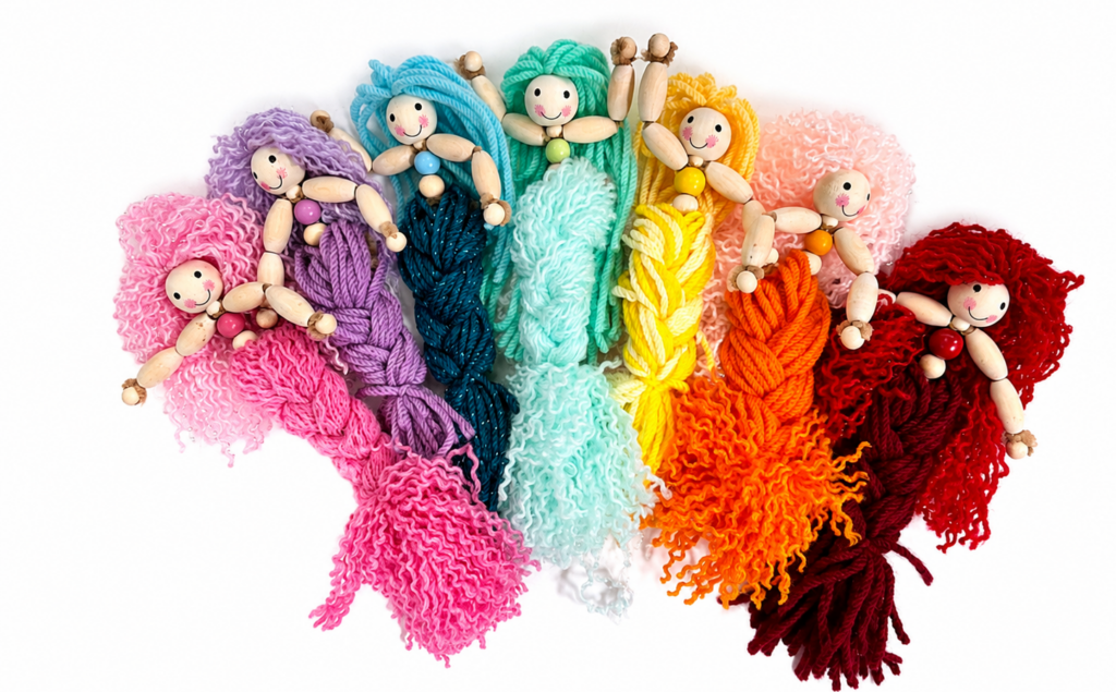 Finished DIY yarn mermaid doll made with wooden beads, pipe cleaners and a braided yarn tail.
