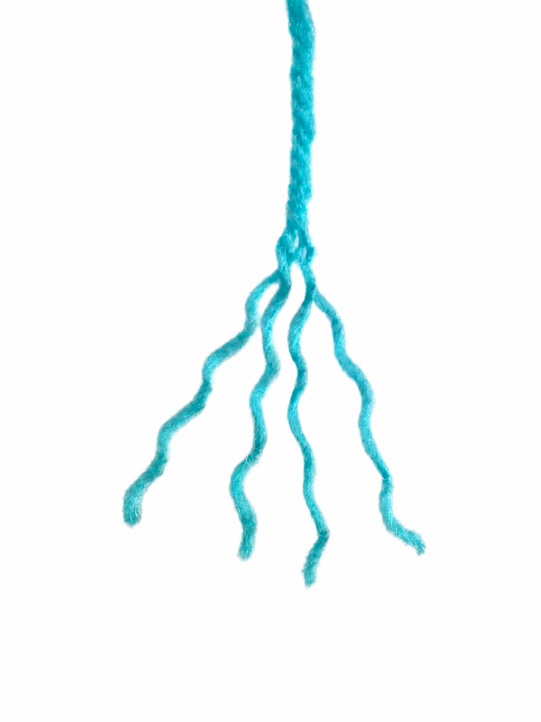 Soften the mermaid by unraveling the yarn hair