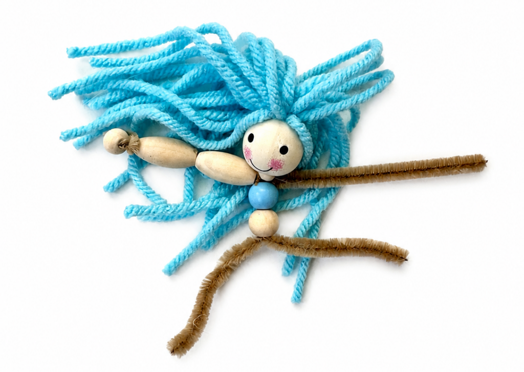 Pipe cleaners positioned below the wooden bead body before adding the yarn tail to a mermaid doll.