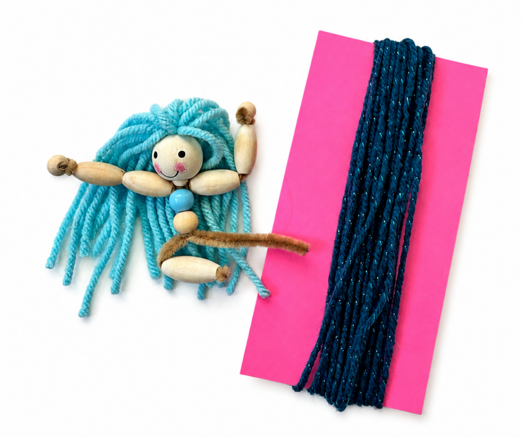 Pipe cleaners positioned below the wooden bead body before adding the yarn tail to a mermaid doll.