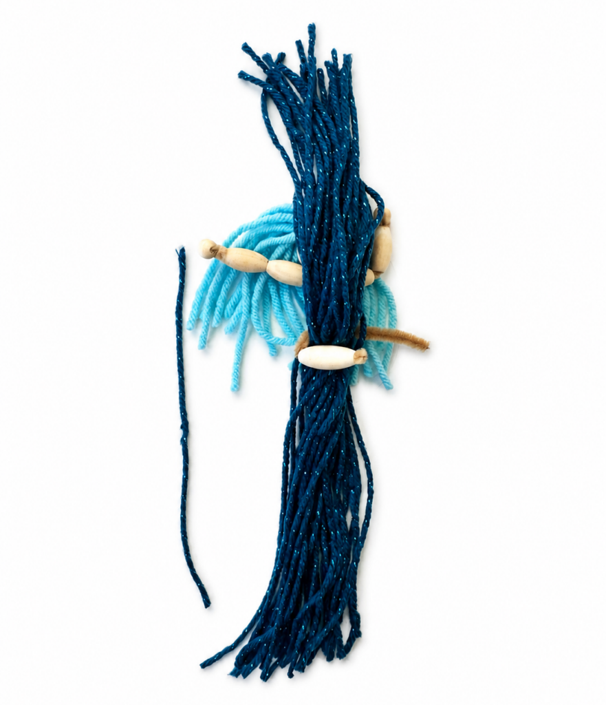 Yarn being measured and cut into long strands for the braided tail of a DIY mermaid doll.