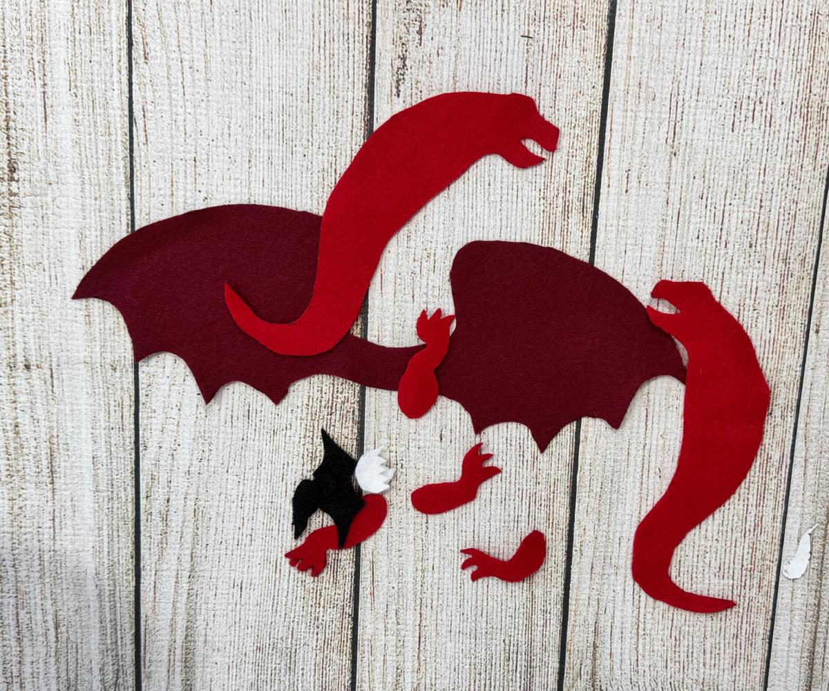 Felt dragon pattern pieces traced and cut from colorful felt