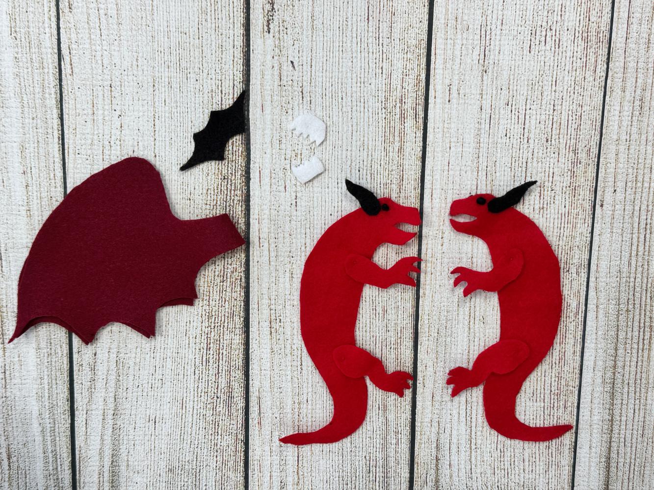 Black eye and facial details added to a handmade felt dragon