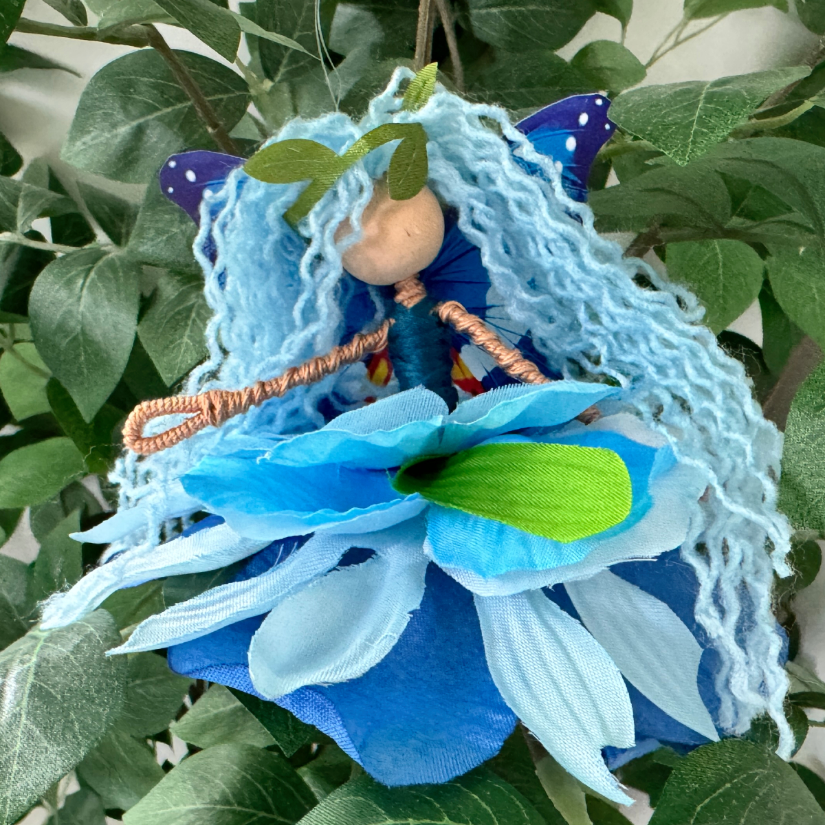 DIY adult fiber art flower fairy doll craft tutorial with colorful handmade yarn fairy, flower petal skirts, butterfly wings, and fairy craft kit supplies to make fairies.