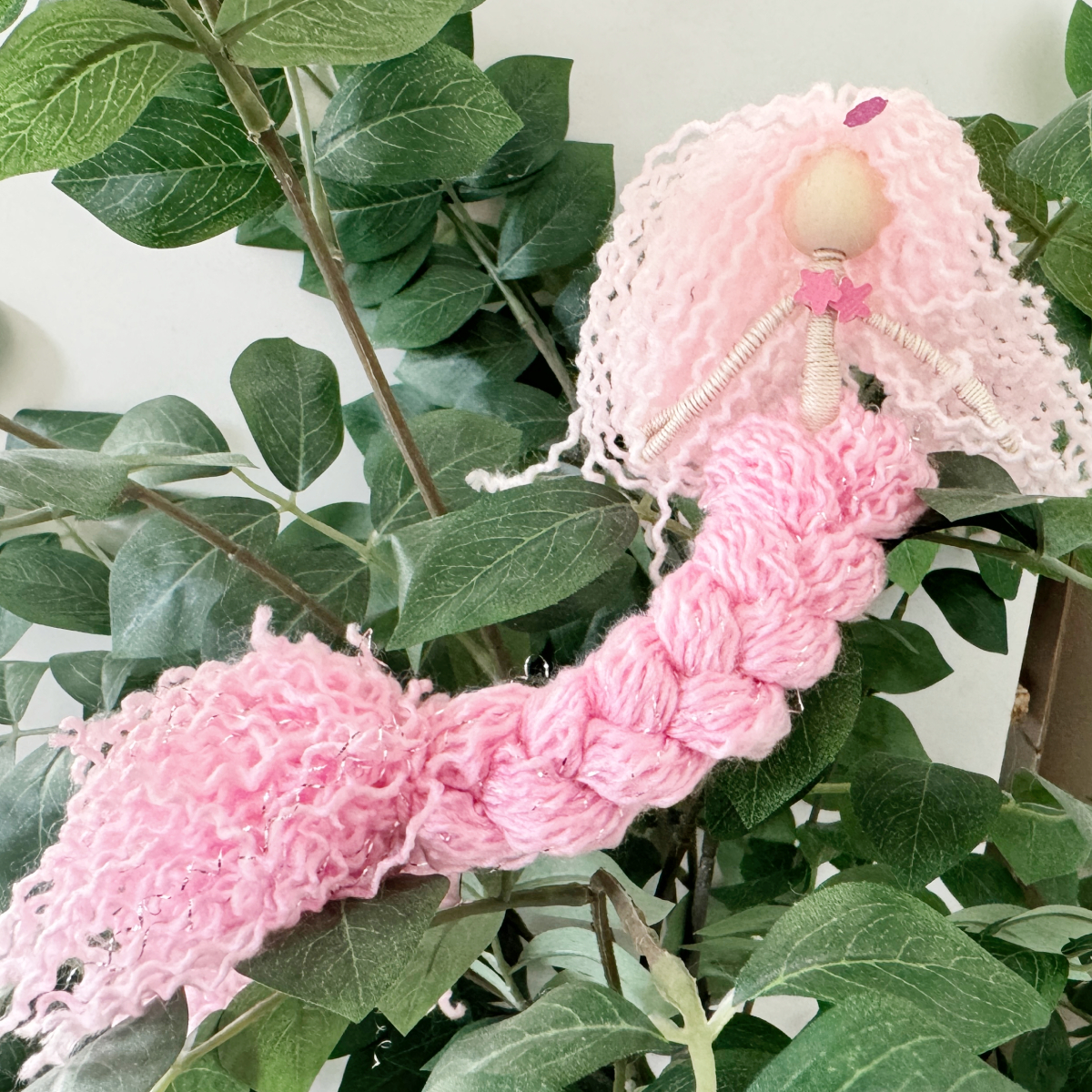 Handmade fiber art mermaids in multiple yarn colors showing finished DIY string art mermaid ideas for beginners.