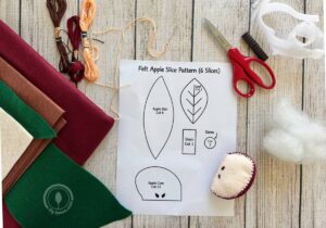 Felt, embroidery thread, scissors, stuffing, and a free felt apple pattern