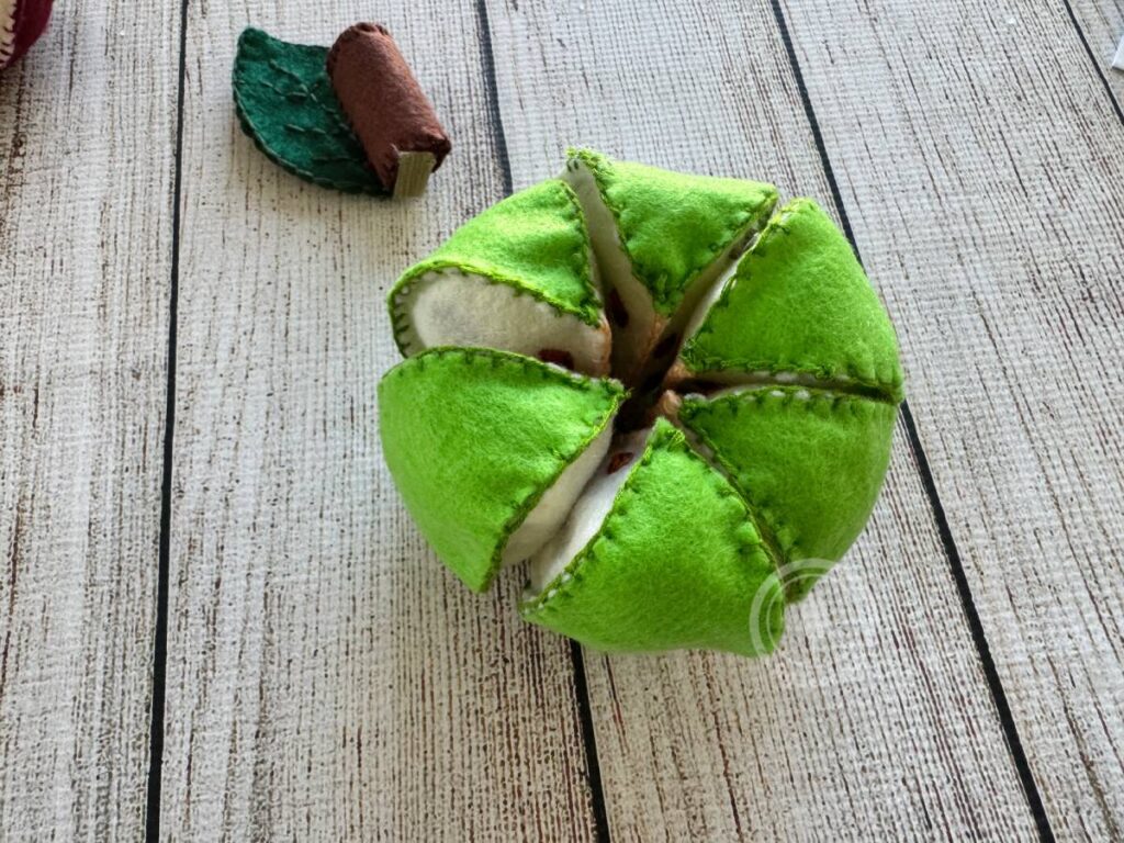 Green pull-apart felt apples with removable slices and stitched seeds