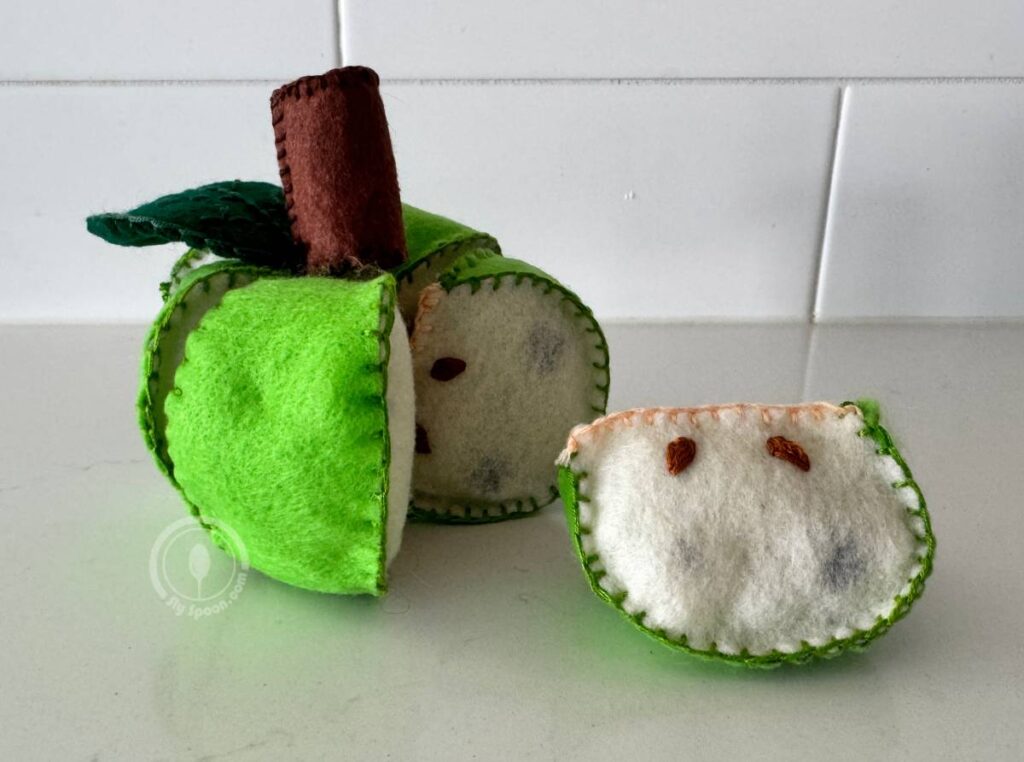 Green pull-apart felt apples with removable slices and stitched seeds