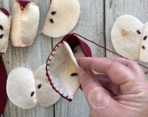 At 3/4s of the way to the top of the apple pause to stuff it before sewing closed
